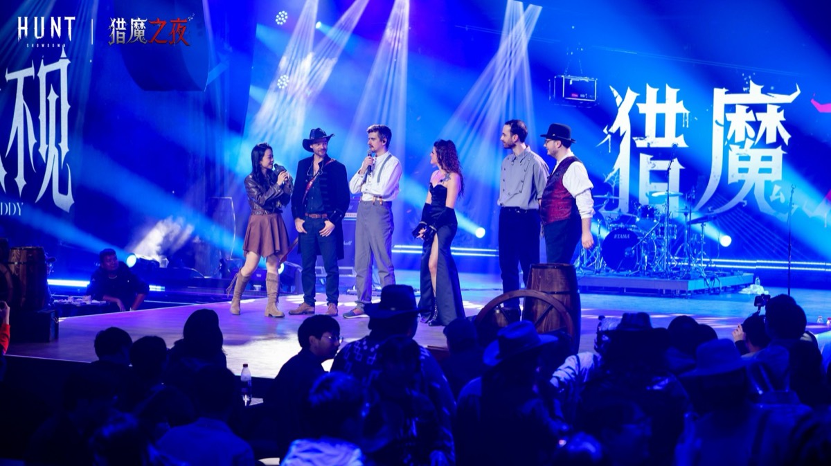 The band on a large stage in front of a full room
